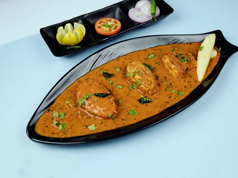 Fish curry plated with garnish